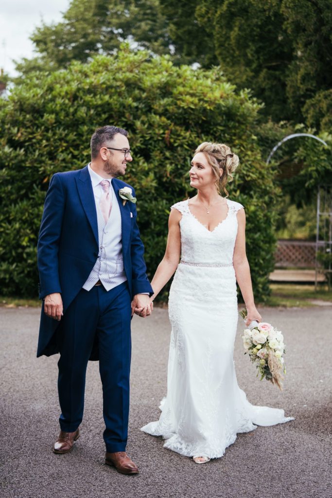 Bride and groom walking holding hands